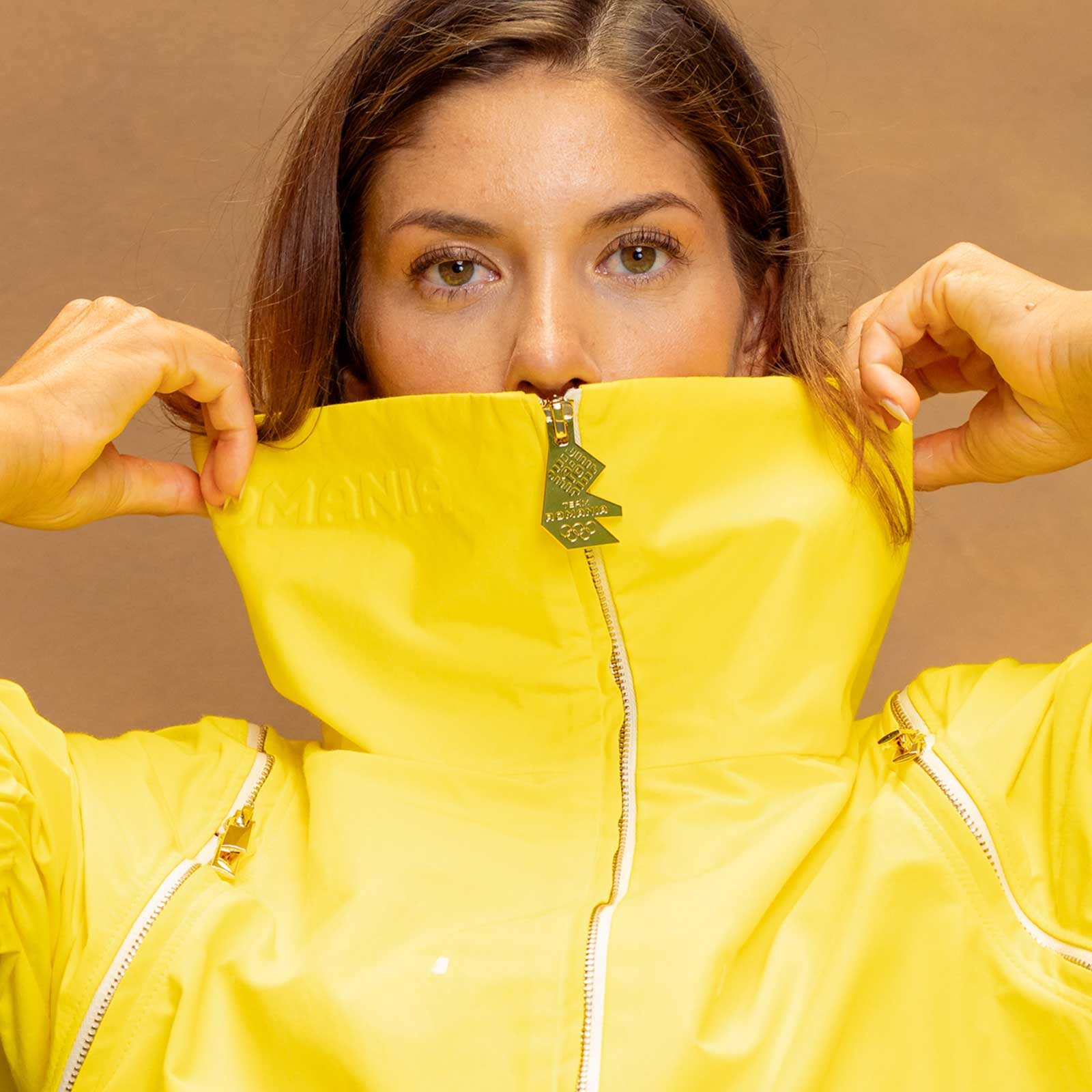 Team Romania's Paris 2024 Olympic parade outfit — the yellow jacket carrying the new Team Romania emblem, the emblem also forming the gold zip-pull.