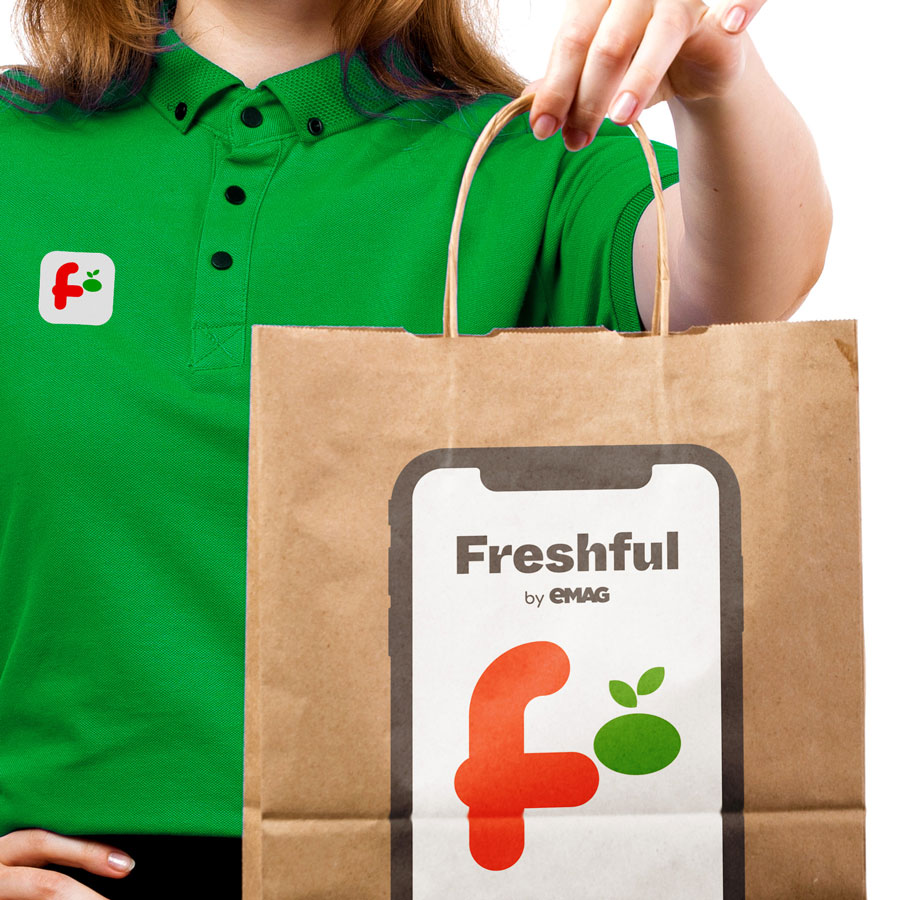 Freshful courier in green polo holding logo paper bag — new brand creation for Dante International by Brandient